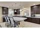 Kitchen features dark wood cabinets, granite countertops, pendant lighting, and large island at 5448 Tulip Hill Ave, Las Vegas, NV 89141