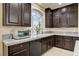 Kitchen with dark wood cabinets, granite countertops and stainless steel appliances at 5448 Tulip Hill Ave, Las Vegas, NV 89141