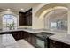 A spacious kitchen features granite countertops, an undermount sink, and dark wood cabinets at 5448 Tulip Hill Ave, Las Vegas, NV 89141