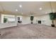 Spacious living room featuring a fireplace, ceiling fan, and neutral color palette at 5448 Tulip Hill Ave, Las Vegas, NV 89141