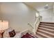 Carpeted staircase with white banister and a decorative chair at 5448 Tulip Hill Ave, Las Vegas, NV 89141