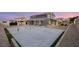 A backyard with a patio and tennis court, offering a perfect space for outdoor activities at 5449 Hickory Tree St, Las Vegas, NV 89149