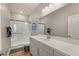 Modern bathroom featuring a glass-enclosed shower, sleek vanity, and stylish wood-look flooring at 5449 Hickory Tree St, Las Vegas, NV 89149