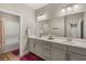 Bright bathroom featuring a dual sink vanity, large mirror, and a tub/shower combination at 5449 Hickory Tree St, Las Vegas, NV 89149