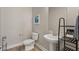 Stylish half bathroom with modern fixtures, pedestal sink, and a decorative mirror at 5449 Hickory Tree St, Las Vegas, NV 89149
