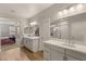 Bathroom featuring double sink vanity, stylish mirrors, and a walk-in shower at 5449 Hickory Tree St, Las Vegas, NV 89149