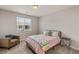 Cozy bedroom with a comfortable armchair, side table, and a window allowing natural light at 5449 Hickory Tree St, Las Vegas, NV 89149