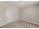 A serene bedroom boasts neutral paint, plush carpet, and a large, white door at 5449 Hickory Tree St, Las Vegas, NV 89149