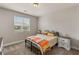 Comfortable bedroom features a window view, two bedside tables, and soft carpeting at 5449 Hickory Tree St, Las Vegas, NV 89149