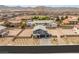 Aerial view of a two story home with a three car garage and neutral desert landscaping at 5449 Hickory Tree St, Las Vegas, NV 89149