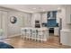 Bright kitchen with white cabinets, a central island with seating, and stainless steel appliances at 5449 Hickory Tree St, Las Vegas, NV 89149