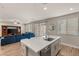Kitchen island with stainless steel sink opens to the living room with large sofa and entertainment center at 5449 Hickory Tree St, Las Vegas, NV 89149