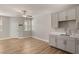 Modern kitchenette featuring neutral cabinets and countertops with light wood flooring at 5449 Hickory Tree St, Las Vegas, NV 89149