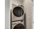 Modern laundry area with stacked washer and dryer units for efficient space saving at 5449 Hickory Tree St, Las Vegas, NV 89149