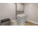 Functional laundry room with washer, dryer, storage cabinets and a utility sink at 5449 Hickory Tree St, Las Vegas, NV 89149