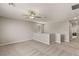 Spacious loft area with neutral carpet, a ceiling fan, and large windows for natural light at 5449 Hickory Tree St, Las Vegas, NV 89149