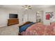 Main bedroom with mounted TV, ensuite bathroom, and stylish decor at 5449 Hickory Tree St, Las Vegas, NV 89149