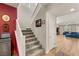 Carpeted staircase with white railings leading to the upper level of the home at 5449 Hickory Tree St, Las Vegas, NV 89149