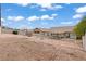 Large backyard featuring desert landscaping and a covered patio at 556 Decidedly St, Henderson, NV 89015