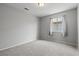 A comfortable bedroom features plush carpeting, a window with natural light, and neutral paint for a calming atmosphere at 556 Decidedly St, Henderson, NV 89015