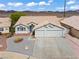 Charming home showcasing a well-maintained front yard with desert landscaping and a two-car garage at 556 Decidedly St, Henderson, NV 89015