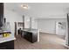 Stylish kitchen with dark cabinetry, modern appliances, and an open layout connecting to the living area at 556 Decidedly St, Henderson, NV 89015