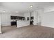 Open kitchen with granite countertops, dark cabinets, stainless steel appliances, and modern fixtures at 556 Decidedly St, Henderson, NV 89015