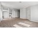 Spacious living room with wood flooring, light gray walls, and natural light from the windows at 556 Decidedly St, Henderson, NV 89015