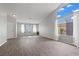 Bright, airy living room featuring wood floors, neutral walls, and large windows letting in natural light at 556 Decidedly St, Henderson, NV 89015