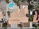 Aerial view of a home with a private pool and desert landscaping in a quiet neighborhood at 5912 Hollowridge Rd, North Las Vegas, NV 89031