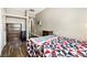Bedroom features a colorful comforter, wood-look floors, and closet at 5912 Hollowridge Rd, North Las Vegas, NV 89031