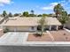 Charming single-story home featuring a well-maintained front yard and a three-car garage at 5912 Hollowridge Rd, North Las Vegas, NV 89031