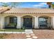 Inviting front porch with double doors, a cozy bench, and attractive landscaping at 5912 Hollowridge Rd, North Las Vegas, NV 89031