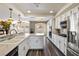 Spacious kitchen featuring a large island, white cabinetry, and stainless steel appliances at 5912 Hollowridge Rd, North Las Vegas, NV 89031