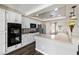 Well-lit kitchen featuring white cabinets, stainless steel appliances, and a stylish tile backsplash at 5912 Hollowridge Rd, North Las Vegas, NV 89031