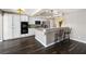 Bright kitchen with white cabinetry, a breakfast bar, and modern pendant lighting at 5912 Hollowridge Rd, North Las Vegas, NV 89031