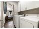Laundry room featuring a washer, dryer, white cabinets, and tile floors at 5912 Hollowridge Rd, North Las Vegas, NV 89031