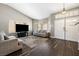 Bright living room featuring wood flooring and neutral-toned furniture at 5912 Hollowridge Rd, North Las Vegas, NV 89031