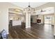 Expansive living space showcasing open floor plan and flowing transition to kitchen and fireplace at 5912 Hollowridge Rd, North Las Vegas, NV 89031