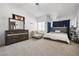Relaxing main bedroom with a dresser, comfortable seating, and ample natural light at 5912 Hollowridge Rd, North Las Vegas, NV 89031