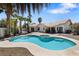 Backyard oasis featuring a pool, spa, palm trees, and covered patio at 5912 Hollowridge Rd, North Las Vegas, NV 89031