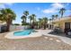 Backyard featuring a pool, spa, palm trees, and patio area at 5912 Hollowridge Rd, North Las Vegas, NV 89031