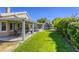 Expansive backyard with lush lawn, covered patio, and mature landscaping at 6021 Winter Meadow St, Las Vegas, NV 89130