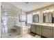 Bathroom featuring a modern shower, soaking tub, double vanity, and tiled walls at 6021 Winter Meadow St, Las Vegas, NV 89130