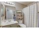 Cozy bathroom featuring a tub, a shower with curtain and practical shelving at 6021 Winter Meadow St, Las Vegas, NV 89130