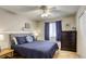 Cozy bedroom with a ceiling fan, comfortable bed, and bright window at 6021 Winter Meadow St, Las Vegas, NV 89130