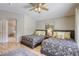 Comfortable bedroom featuring two beds and an ensuite bathroom with a shower at 6021 Winter Meadow St, Las Vegas, NV 89130