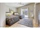 Bright bedroom featuring two beds, a ceiling fan, and glass sliding door to outside at 6021 Winter Meadow St, Las Vegas, NV 89130