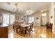 Spacious dining area with a decorative chandelier, large windows, and ample seating around the wooden table at 6021 Winter Meadow St, Las Vegas, NV 89130