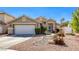 Charming single-story home featuring a well-maintained landscape, gravel yard, and a two-car garage at 6021 Winter Meadow St, Las Vegas, NV 89130